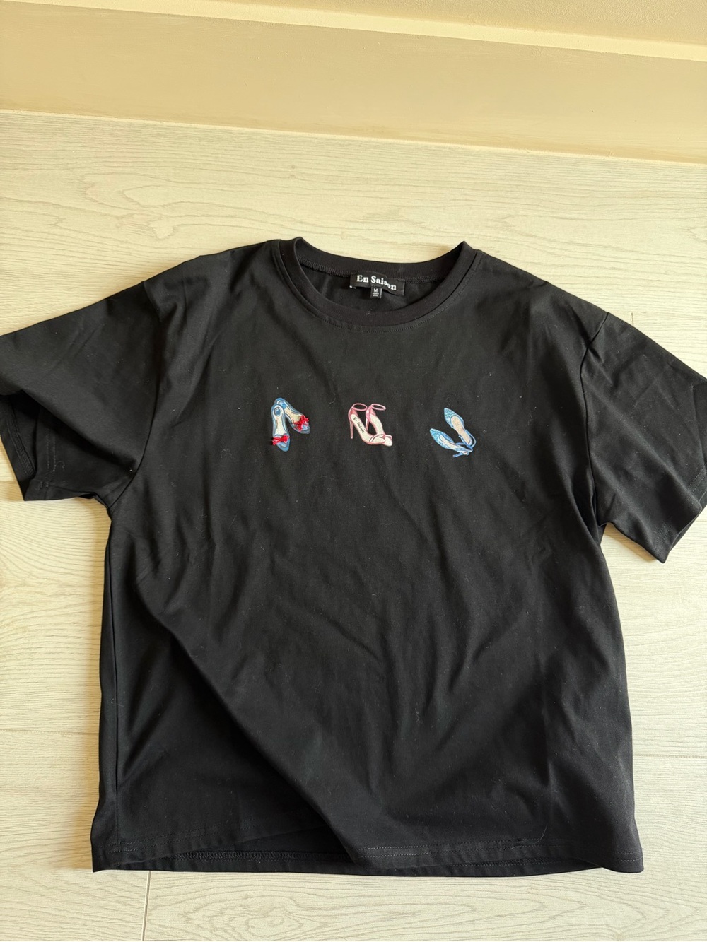 En Saison Black Graphic Tee with Colorful Shoe Motif